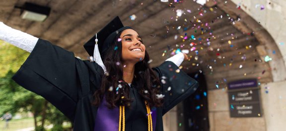 Girl graduate throwing confetti